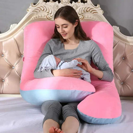 Woman breastfeeding a baby using a pink and blue 130x70cm Pregnancy Pillow on a bed.