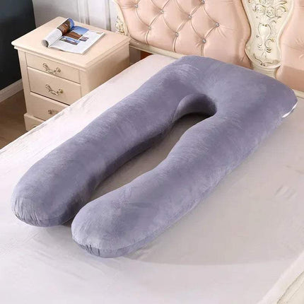 Gray U-shaped 130x70cm Pregnancy Pillow on a bed with a nightstand in the background