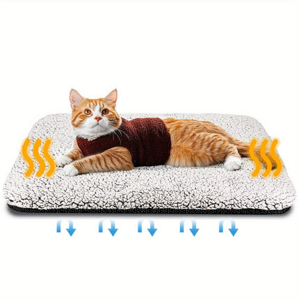 Self-Heating Pet Pad with an orange cat lounging comfortably on a fluffy surface, showcasing natural warmth and coziness.