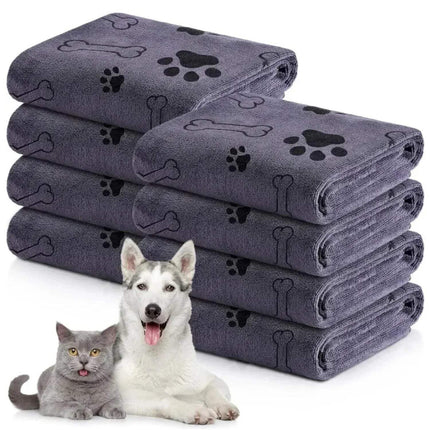 Dog Drying Towel - Ultra-absorbent microfiber pet towels stacked with a dog and cat in front, perfect for drying pets.