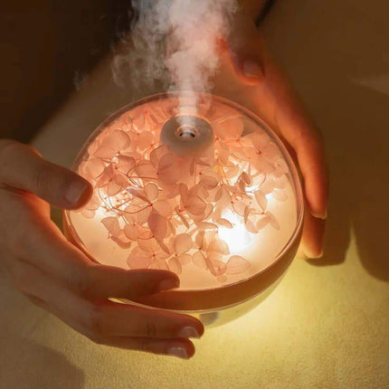 270ML Flower Air Humidifier Hand holding a diffuser emitting steam with a warm glow