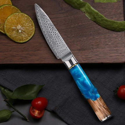 3.5 Inch Paring Knife VG10 Damascus Steel  with a blue handle on a wooden cutting board with fruits and vegetables.
