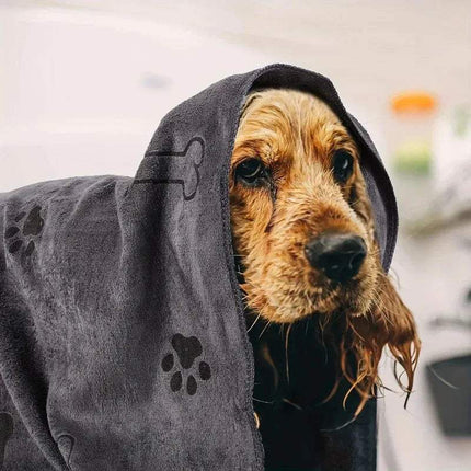 Dog Drying Towel wrapped around a wet dog, showcasing ultra-absorbent microfiber for fast drying.