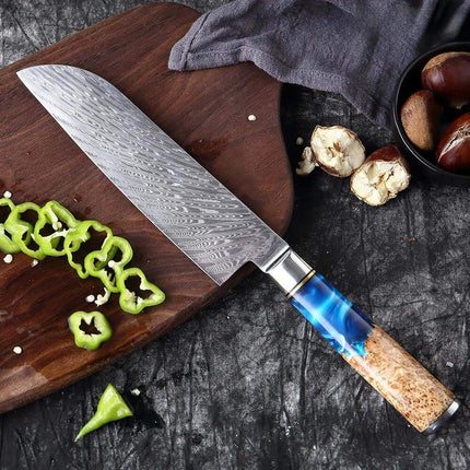 7 Inch Chef Knife  with a blue resin handle on a wooden cutting board with sliced green peppers.