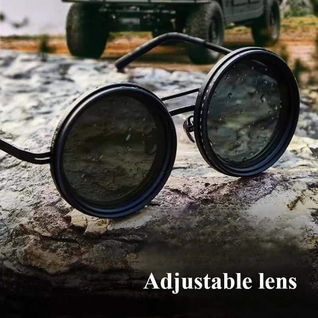 Adjustable Dimming Sunglasses round with adjustable lenses on a rock, with an off-road vehicle in the background.