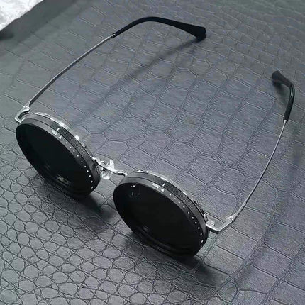 Adjustable Dimming Sunglasses Round sunglasses with metallic frame on a textured gray surface