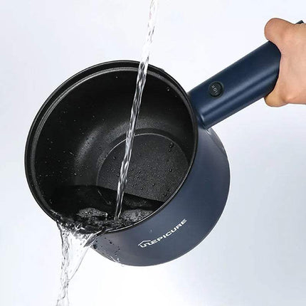 Blue All-In-One Mini Electric Cooker being used to pour water, with 'Napicure' branding visible.