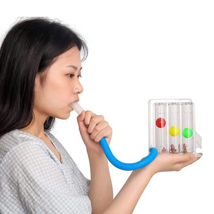 breathing balls exerciser Person using a colorful toy with a blue tube on a white background