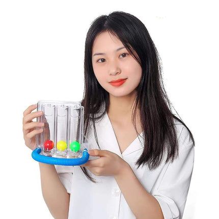 breathing balls exerciser Woman holding a transparent container with colorful beads on a white background