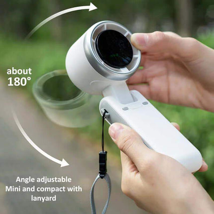 Handheld Turbo Fan device with adjustable angle and lanyard, held by a person outdoors.