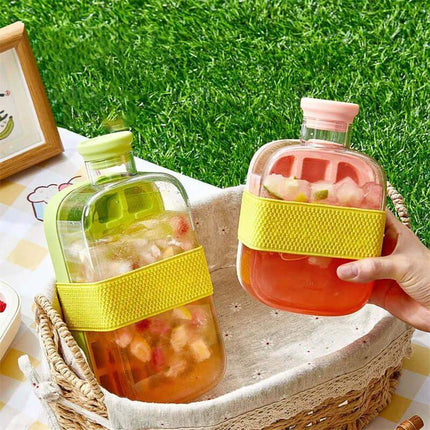 Ice Cube Tray With Straw, featuring colorful drinks in stylish bottles with vibrant bands, set outdoors on a picnic.