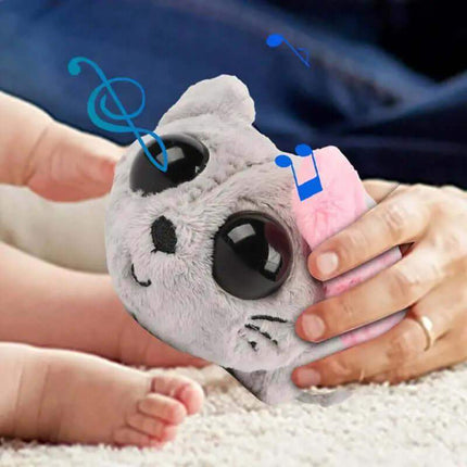 Sad Hamster Plush Toyt with a pink heart, held by a person, with musical notes above it.