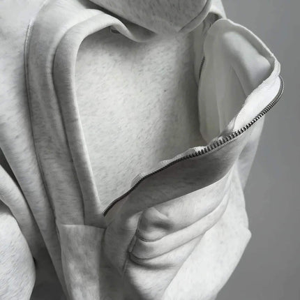 Hoodie - Close-up of a textured fabric with a zipper detail on a neutral background