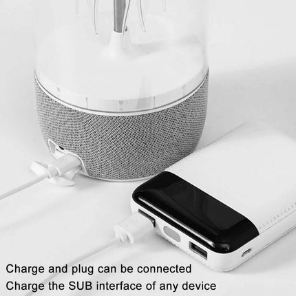 Jellyfish Lamp Speaker with charging cable and headphones on a light gray background