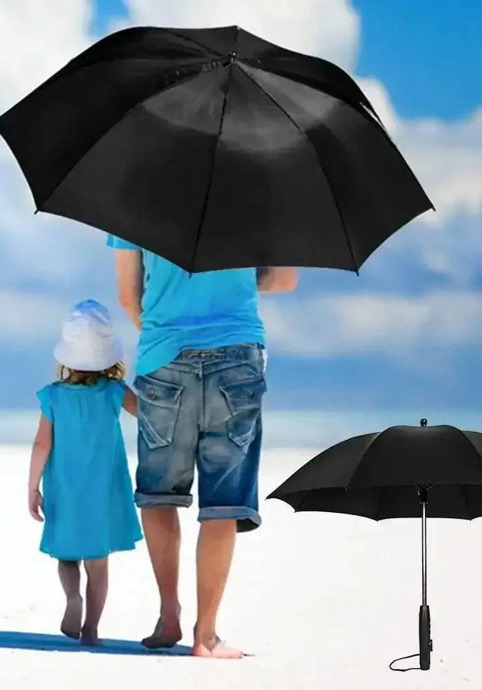 portable umbrella with fan Person and child walking on a beach with a large black umbrella, another black umbrella is shown on the right.