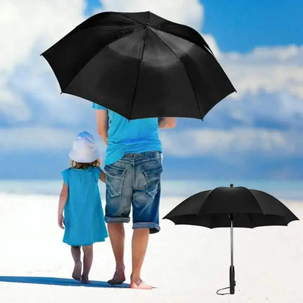 portable umbrella with fan Person and child walking on a beach with a large black umbrella, another black umbrella is shown on the right.