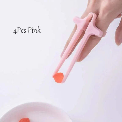 Snack Grabbers Pink with red ends being held by a hand on a light gray background.