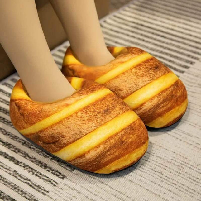 Bread Slippers shaped like a loaf of bread with striped design worn by a person on a textured floor.