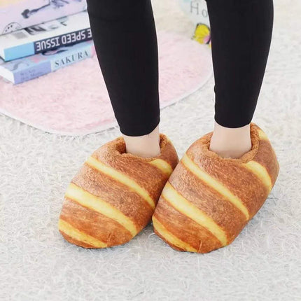 Bread Slippers. Person wearing croissant-shaped slippers on a light background