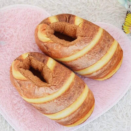 Bread Slippers. Two plush bagels on a pink surface