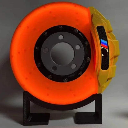 Creative DIY Brake Disc LED Atmosphere Light décor with vibrant orange glow and yellow caliper design.