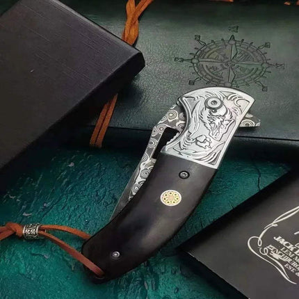 Damascus Steel Pocket Knife displayed with a dark wooden handle and intricate engravings on the blade.