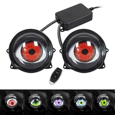 Car fog lights with red and green 'eyes' and a remote control on a white background.