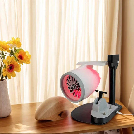 Jet Engine Fan Humidifier with LED light on a desk next to a wooden mouse and flowers, enhancing workspace comfort.