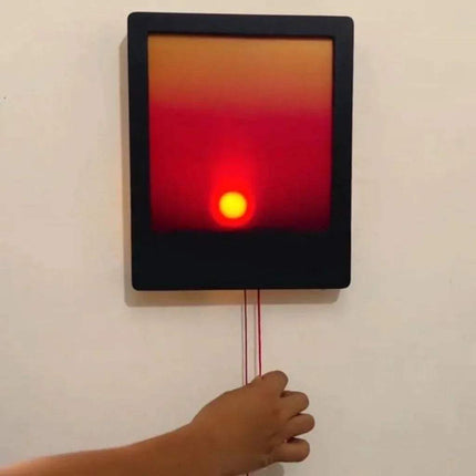 Kinetic Sunrise Wall Light adjustable sunset glow lamp with warm colors and hand adjusting the brightness