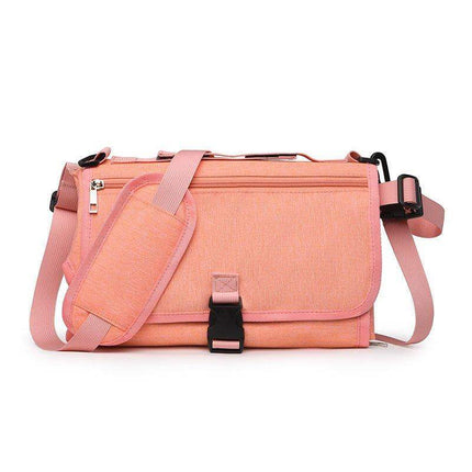 Pink Portable Baby Changing Pad Foldable Waterproof Diaper Mat for Travel bag with black straps on a white background