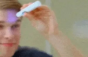 A person using the Blue Light Therapy Pen for Clear & Youthful Skin on their forehead.