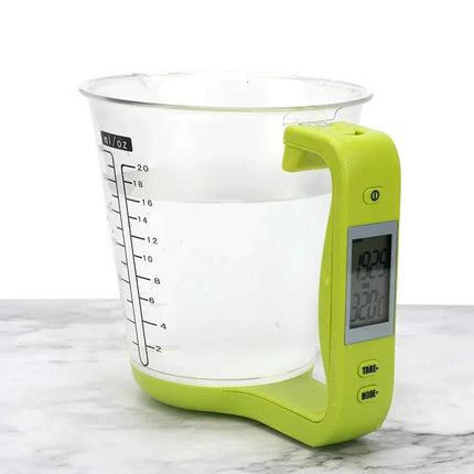 Digital Measuring Cup with green handle and digital display on a marble surface. Astoria Lifestyle