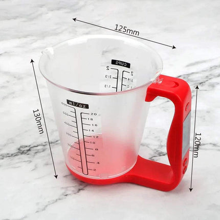 Digital Measuring Cup with red handle on a marble background. Astoria Lifestyle