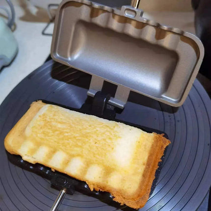Double-Sided Non-Stick Foldable Sandwich Frying Pan Grill cooking a perfectly toasted sandwich on a stove. Astoria Lifestyle