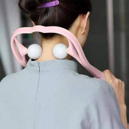 Woman using a Dual Pressure Point Massager on her neck for instant pain relief and muscle relaxation.