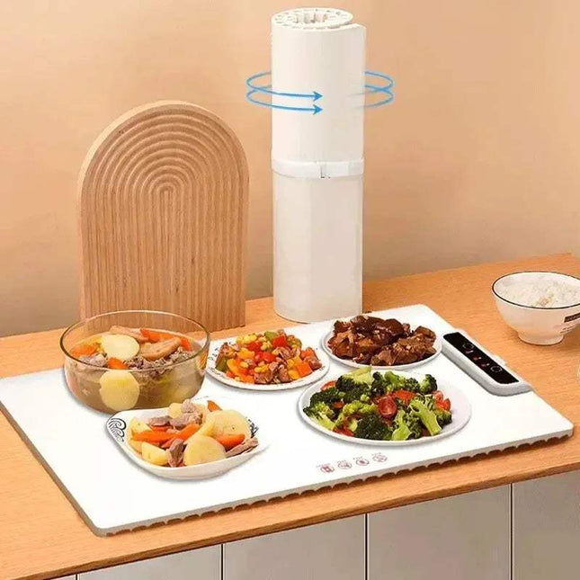 Foldable Food Heating Mat displaying warm meals including vegetables and meats on a kitchen countertop. - Astoria Lifestyle