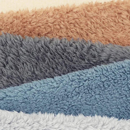 Stack of textured Fuzzy Leg Warmer Stockings in brown, gray, blue, and white.