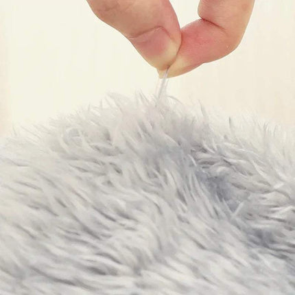 Close-up of a hand holding a white thread over Fuzzy Leg Warmer Stockings