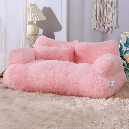 Luxury Cat Plush Bed Pink fluffy pet bed on a carpeted floor with a lamp and decorative items in the background.