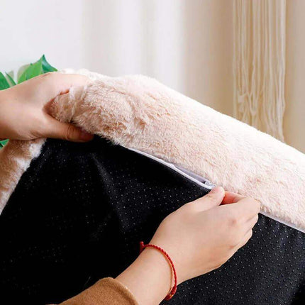 Luxury Cat Plush Bed Person opening a black bag with a fluffy white surface in the background