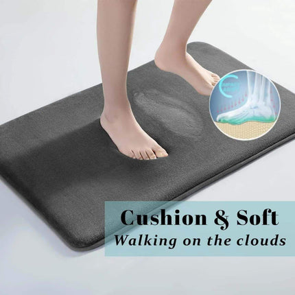Memory Foam Bathroom Mat. Gray cushioning mat with feet stepping onto it, promotional text 'Cushion & Soft Walking on the clouds'.