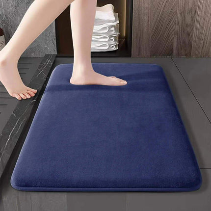 Memory Foam Bathroom Mat. Person stepping onto a blue bath mat in a bathroom setting