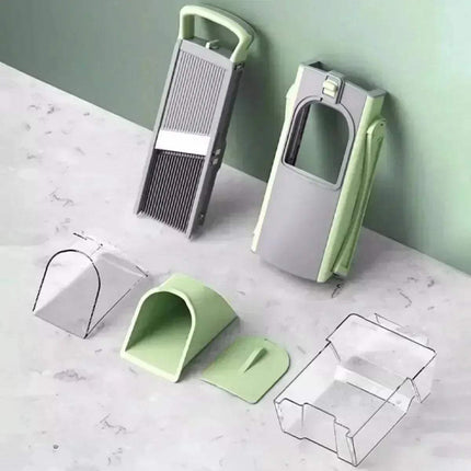 Green and gray Multi-Functional Vegetable Cutter set on a marble surface with a light green wall background.