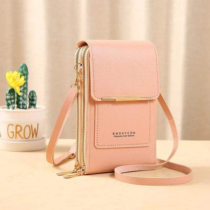 Pink Small Bag for Females with Transparent Touch Screen Area with gold accents on a light surface with a blurred background