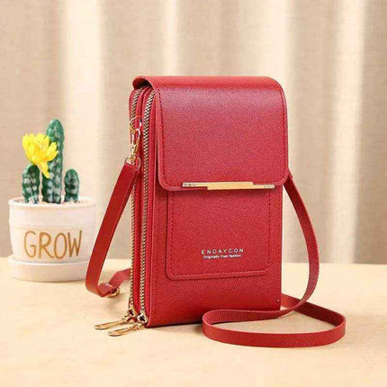 Red Small Bag for Females with Transparent Touch Screen Area with gold accents on a beige surface, next to a potted plant with 'GROW' written on it.