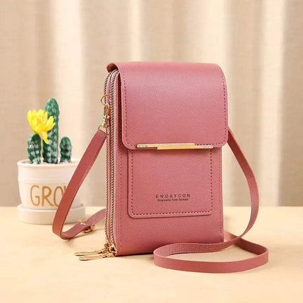 Dark Pink Small Bag for Females with Transparent Touch Screen Area with gold accents on a beige surface with a plant in the background