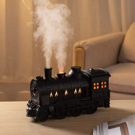 Train Air Humidifier emitting steam on a wooden surface with a blurred background