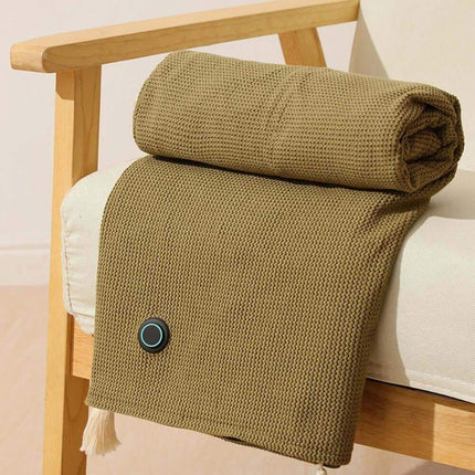 Folded brown Wearable Electric Heating Blanket on a wooden chair with a white cushion