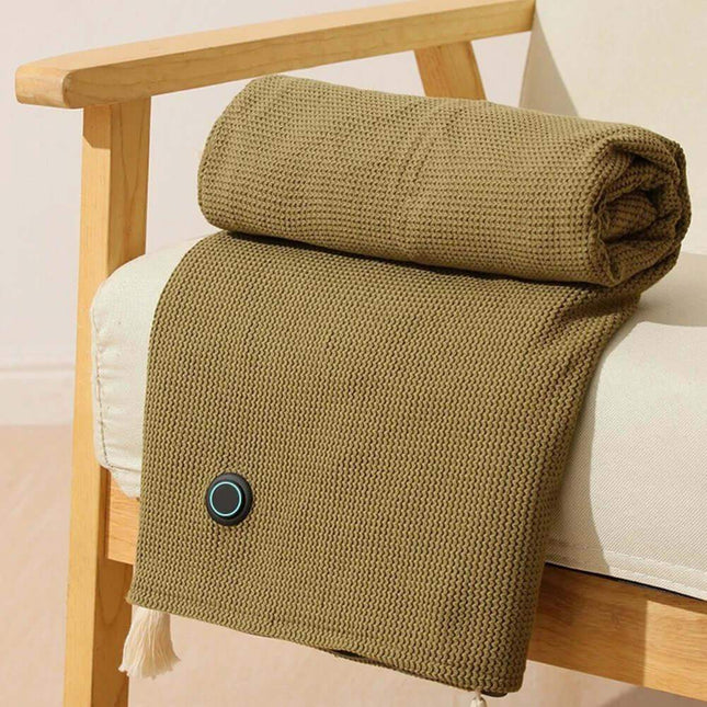 Folded brown Wearable Electric Heating Blanket on a wooden chair with a white cushion