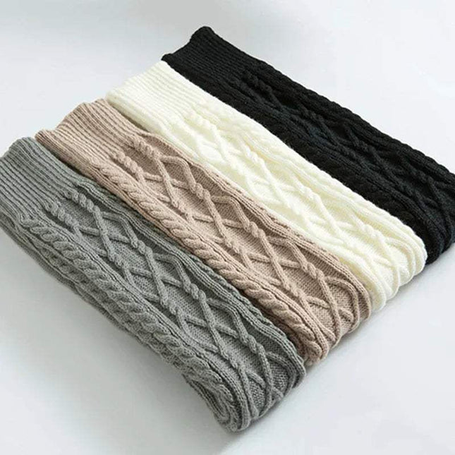 Stack of Winter Wool Over Knee Socks in gray, beige, white, and black on a light background